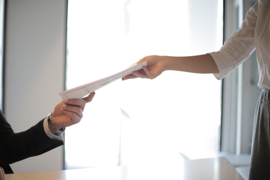 job-applicant-passing-her-documents-3760072